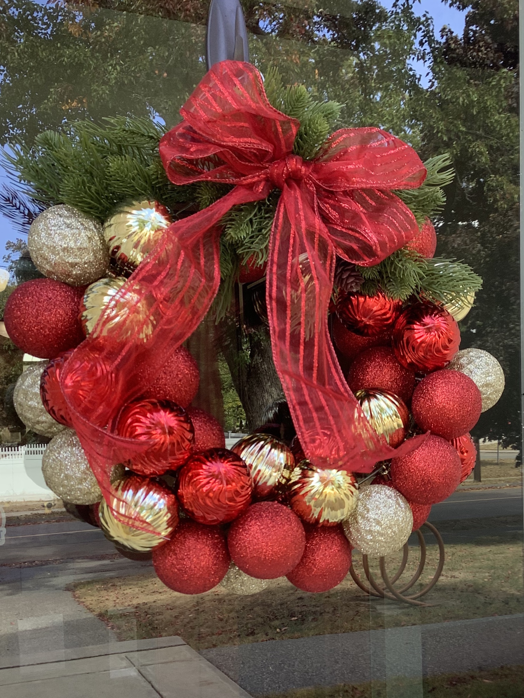 Red and gold colored ornaments fashioned into a wreath