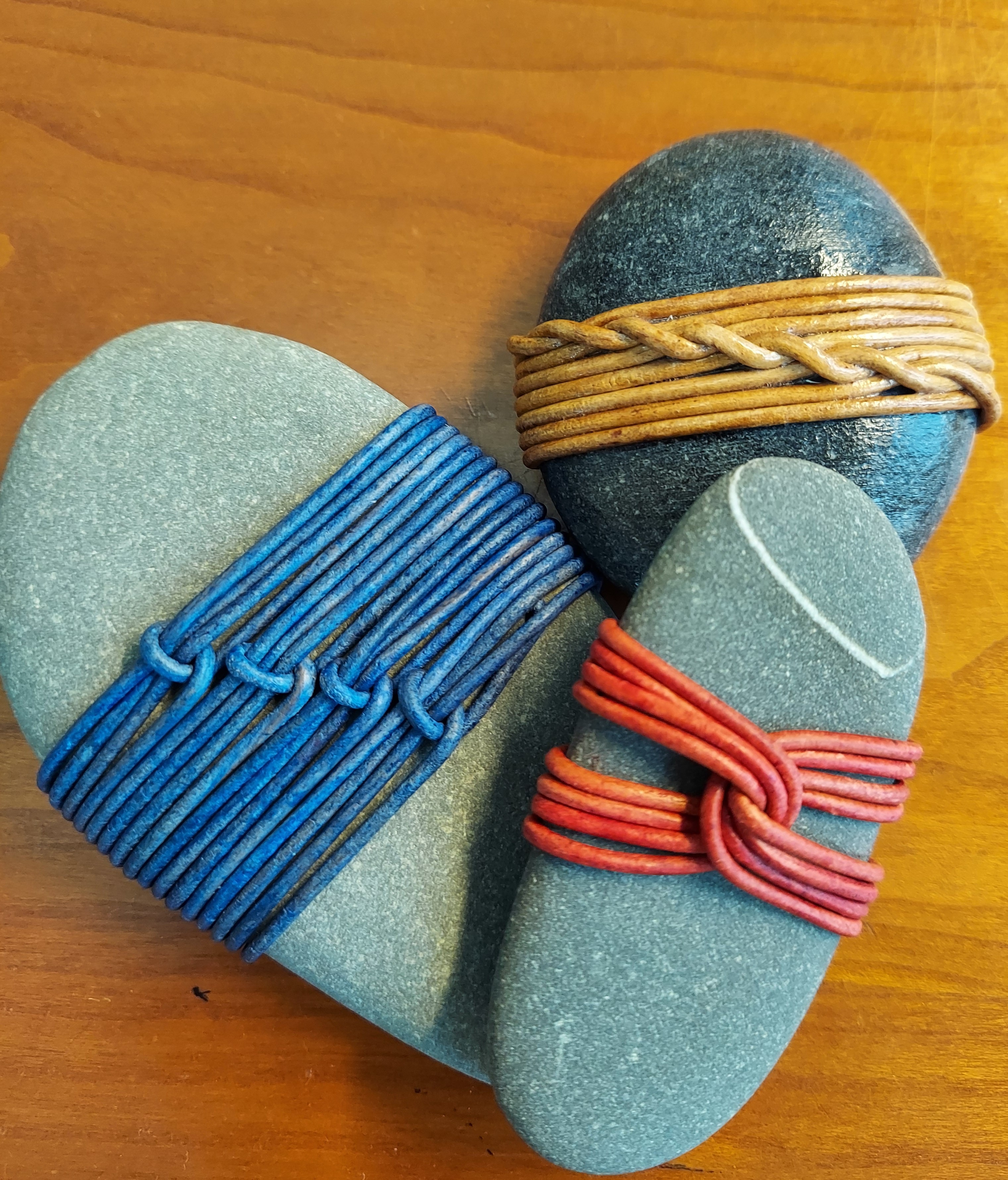 Three beach rocks wrapped in cording