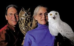 Man & woman holding live owls