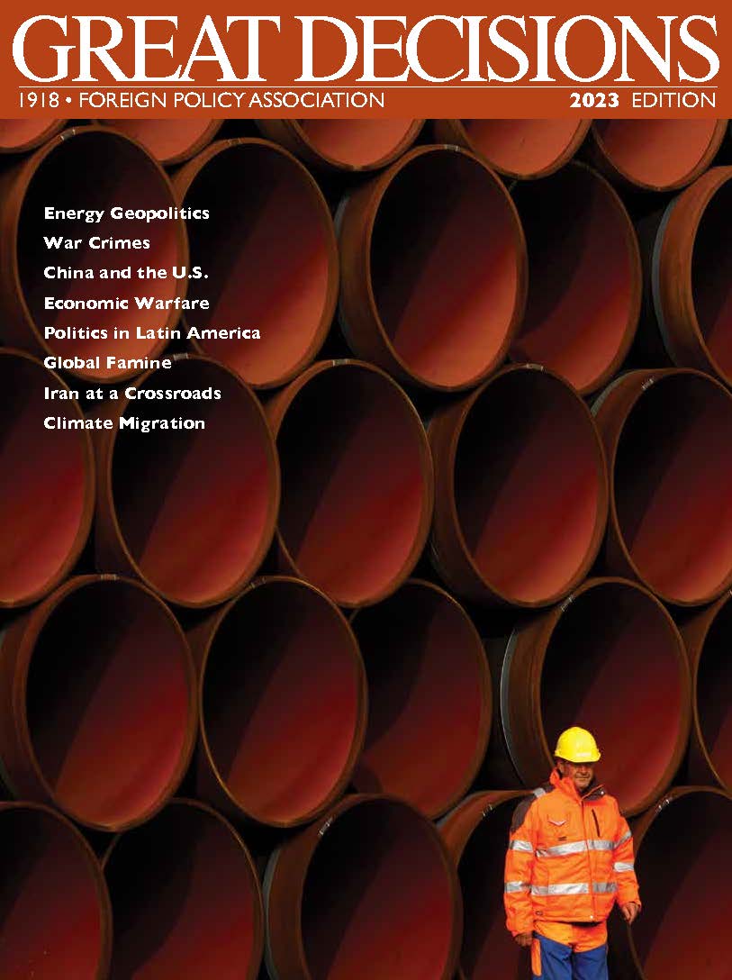 Man standing in front of  industrial pipes