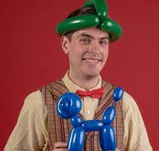 Man with balloon hat