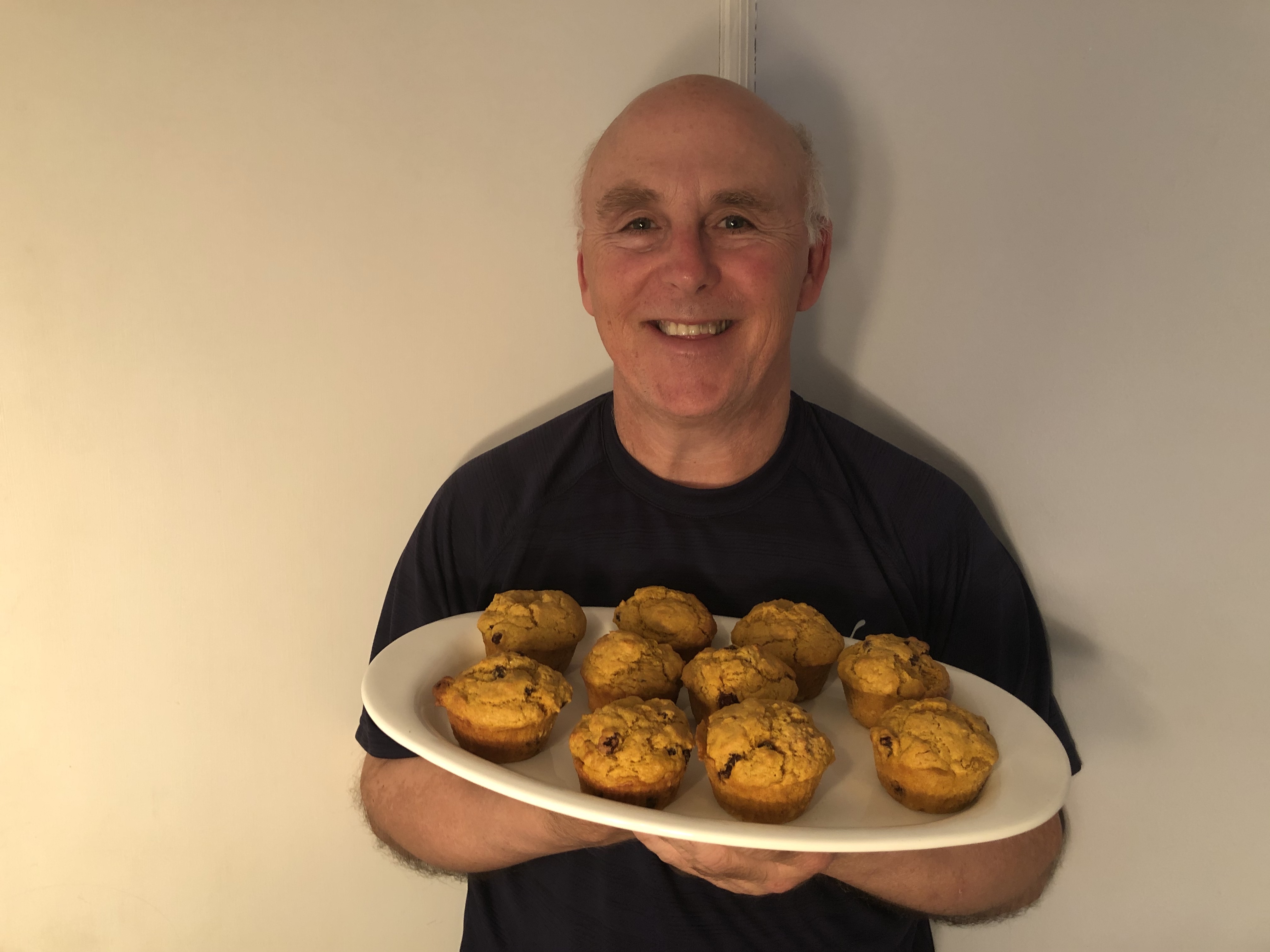 Chef Rob holding a plate of sweet potato muffins
