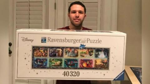 Jack Brait holding a giant puzzle box