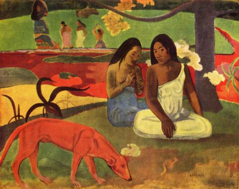 Two women sitting under a tree