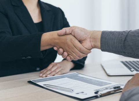 An employer shaking the hand of a job applicant