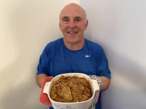 Chef Rob holding a dish of his baked praline french toast casserole