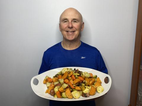 Chef Rob holding a plate of his roasted root vegetables