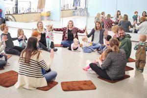 Children and caregivers participating in music and movement 