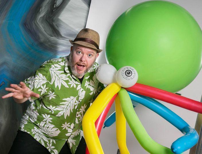 Man with giant octopus balloon sculpture